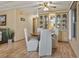 Cozy dining room with a wooden table set, cabinet with glass doors, and a ceiling fan at 6719 Canterbury Ne Dr, Winter Haven, FL 33881