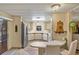 Well-lit kitchen featuring stainless steel appliances, light wood cabinets, and a breakfast bar area at 6719 Canterbury Ne Dr, Winter Haven, FL 33881