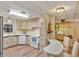 Spacious kitchen with modern appliances, light wood cabinetry, and a breakfast bar with seating at 6719 Canterbury Ne Dr, Winter Haven, FL 33881