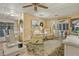 Cozy living room featuring comfortable recliners and sliding glass doors to sunroom at 6719 Canterbury Ne Dr, Winter Haven, FL 33881