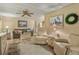 Welcoming living room with plush seating, ceiling fan, and bright decor at 6719 Canterbury Ne Dr, Winter Haven, FL 33881