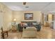 Comfortable living space featuring a sofa and a view into sunroom at 6719 Canterbury Ne Dr, Winter Haven, FL 33881