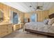 Tranquil main bedroom with a comfortable bed, dresser, and two windows with natural light at 6719 Canterbury Ne Dr, Winter Haven, FL 33881