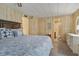 The primary bedroom with ceiling fan, walk in shower, and coastal decor at 6719 Canterbury Ne Dr, Winter Haven, FL 33881