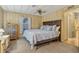 Comfortable main bedroom featuring a large bed, ceiling fan, dresser, and ample natural light at 6719 Canterbury Ne Dr, Winter Haven, FL 33881