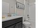 Clean bathroom featuring a vanity with storage, a toilet, and a shower-tub combination at 718 Whistling Straits Blvd, Davenport, FL 33896