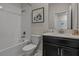 Clean bathroom featuring a shower over tub, white subway tiles, a black vanity, and modern fixtures at 718 Whistling Straits Blvd, Davenport, FL 33896