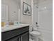 Bathroom featuring a shower over tub, white subway tiles, a black vanity, and modern fixtures at 718 Whistling Straits Blvd, Davenport, FL 33896