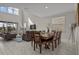 Open-concept living area with a dining table set, plenty of light, and modern decor at 718 Whistling Straits Blvd, Davenport, FL 33896