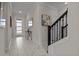 Bright entryway featuring elegant marble floors, modern decor, and staircase with black railing at 718 Whistling Straits Blvd, Davenport, FL 33896