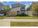 Two-story home boasts stone accents, a vibrant yellow garage door, and well-maintained landscaping at 718 Whistling Straits Blvd, Davenport, FL 33896
