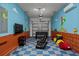 Finished garage features a Mario theme, checkered floors, chairs, and an air conditioner at 718 Whistling Straits Blvd, Davenport, FL 33896