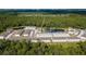 An aerial view of the townhouses with a scenic view of the surrounding wooded area and pond at 7521 Stone Creek Trl, Kissimmee, FL 34747