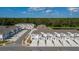 A neighborhood with a scenic view of townhouses, driveways, sidewalks, and a lush green backdrop at 7521 Stone Creek Trl, Kissimmee, FL 34747