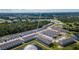 A view of the townhouses with a scenic view of the surrounding ponds, wooded area, and roads at 7521 Stone Creek Trl, Kissimmee, FL 34747