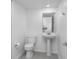Modern half-bathroom with a pedestal sink and tiled floor at 7521 Stone Creek Trl, Kissimmee, FL 34747