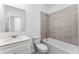 Bathroom featuring tile shower, bath and single sink vanity at 7521 Stone Creek Trl, Kissimmee, FL 34747