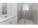 Bathroom features single sink vanity with stone counter and tiled stand-up shower at 7521 Stone Creek Trl, Kissimmee, FL 34747