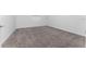 A small bedroom with neutral walls and carpet at 7521 Stone Creek Trl, Kissimmee, FL 34747