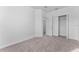 Secondary bedroom with neutral carpet and closet with double doors at 7521 Stone Creek Trl, Kissimmee, FL 34747