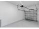 Attached garage with grey concrete floors and automatic door at 7521 Stone Creek Trl, Kissimmee, FL 34747