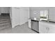Bright kitchen featuring stainless steel appliances, gray countertops, and tile flooring at 7521 Stone Creek Trl, Kissimmee, FL 34747
