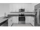 Well-equipped kitchen features stainless steel appliances and white cabinetry at 7521 Stone Creek Trl, Kissimmee, FL 34747