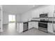 Modern kitchen with stainless appliances, white cabinets, open to dining area at 7521 Stone Creek Trl, Kissimmee, FL 34747