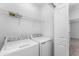 Well-lit laundry room with a side-by-side washer and dryer at 7521 Stone Creek Trl, Kissimmee, FL 34747