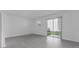 Bright living area featuring gray tile flooring and sliding glass doors at 7521 Stone Creek Trl, Kissimmee, FL 34747