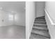 A view of a bright living room with stairs and tile flooring at 7521 Stone Creek Trl, Kissimmee, FL 34747