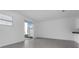 Bright living area featuring gray tile flooring and sliding glass doors at 7521 Stone Creek Trl, Kissimmee, FL 34747