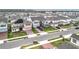 Aerial view of neighborhood with manicured lawns, tasteful landscaping, and well-kept roadways at 7641 Modica St, Clermont, FL 34714