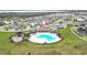 Aerial view of a community featuring a pool, playground, and many homes at 7641 Modica St, Clermont, FL 34714