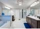 Luxurious bathroom with double vanity, modern shower, freestanding soaking tub, and decorative lighting at 7641 Modica St, Clermont, FL 34714