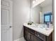 This bathroom features a single sink vanity with a white countertop and dark wood cabinets at 7641 Modica St, Clermont, FL 34714