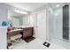 Bathroom boasting a vanity and makeup station, along with a glass-enclosed modern shower at 7641 Modica St, Clermont, FL 34714