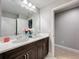 Bathroom with double vanity, neutral paint, and dark wood cabinets at 7641 Modica St, Clermont, FL 34714