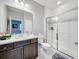 This bathroom offers a single sink vanity with a white countertop and a glass-enclosed shower at 7641 Modica St, Clermont, FL 34714