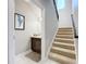 Entryway with stairs and half bathroom with a dark wood vanity and white countertop at 7641 Modica St, Clermont, FL 34714