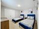 Cozy bedroom features two twin-sized beds with blue velvet frames and stylish decor at 7641 Modica St, Clermont, FL 34714