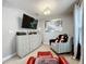 Cozy bedroom featuring a dresser, tv, chair, and ottoman perfect for relaxing at 7641 Modica St, Clermont, FL 34714