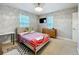Bedroom with neutral walls, carpet, a ceiling fan, and natural light at 7641 Modica St, Clermont, FL 34714