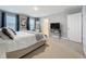 Bright bedroom features plush carpet, natural light, and blue accent curtains at 7641 Modica St, Clermont, FL 34714