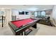 Entertaining bonus room features a pool table, large television, and seating area at 7641 Modica St, Clermont, FL 34714