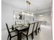 Beautiful dining room featuring a large table, modern chandelier, and decorative mirror at 7641 Modica St, Clermont, FL 34714