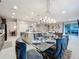 Open-concept dining area adjacent to kitchen, featuring modern lighting and seating for six at 7641 Modica St, Clermont, FL 34714
