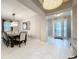 Open dining room space adjacent to the entryway, showcasing a large table and elegant lighting at 7641 Modica St, Clermont, FL 34714