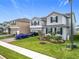 Charming two-story home with a manicured lawn, tasteful landscaping, and a brick driveway at 7641 Modica St, Clermont, FL 34714