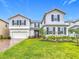 Inviting two-story home with a well-manicured lawn and brick-paved driveway at 7641 Modica St, Clermont, FL 34714
